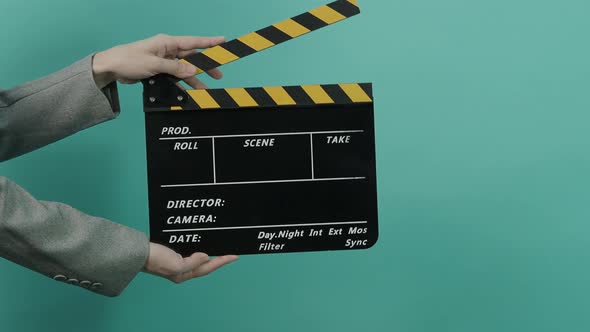 Movie slate or clapperboard hitting. Business woman holding empty film slate and clapping it.