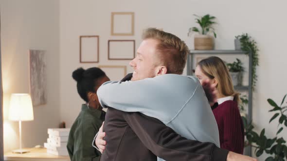 Young Men Greeting and Hugging