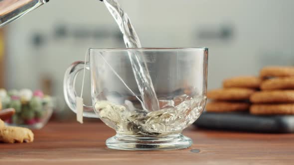 Freshly Brewed Cup of Black Tea on a Wooden Table Tea Ceremony Process Fast Food Water Pouring to