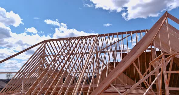 Installation of Wooden Beams at Construction the Roof Truss System of the House