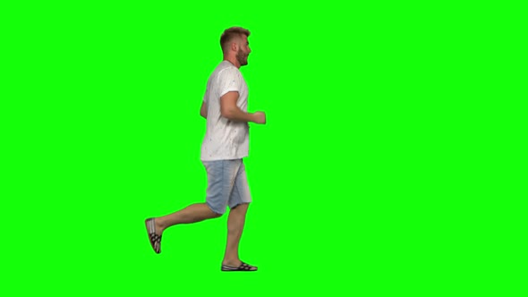 Bearded Guy Calmly Is Running on Green Screen Background. Chroma Key,  Shot. Profile View.