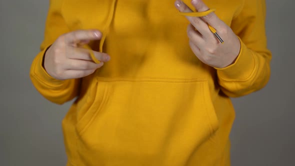 Close Up of Unrecognizable Woman Playing with Laces of Hoodie