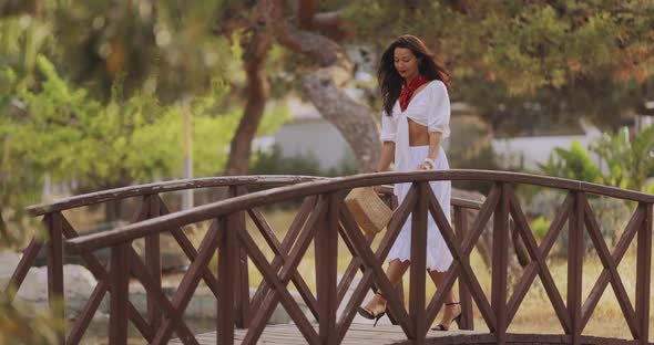 Woman in Elegant Summer Dress Outdoors in the Park Outdoors