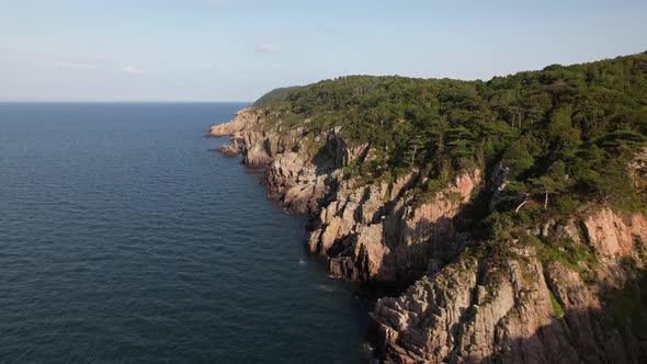 Drone flying forward over beautiful cliff coast, Kullaberg Sweden