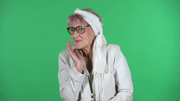 Portrait of Old Stylish Woman Is Saying Oops and Shrugging Expressing She Is Innocent, Isolated Over