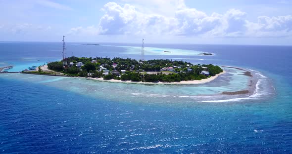 Luxury flying abstract view of a sandy white paradise beach and blue water background in 4K