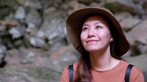 An asian female traveler looking at a beautiful mountain and nature view