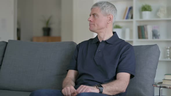 Impatient Middle Aged Businessman Waiting at Home 