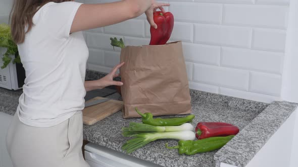 Lady in the Kitchen Looking at the Recipe As She's About to Cook