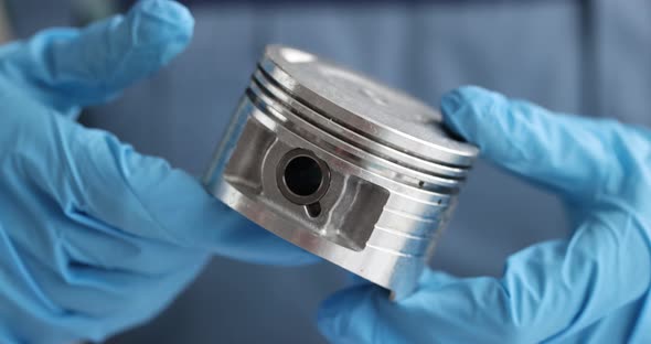 New Engine Piston in Hands of Auto Mechanic Closeup