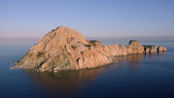 Aerial Panoramic View of Blue Sea with Small Rocky Island