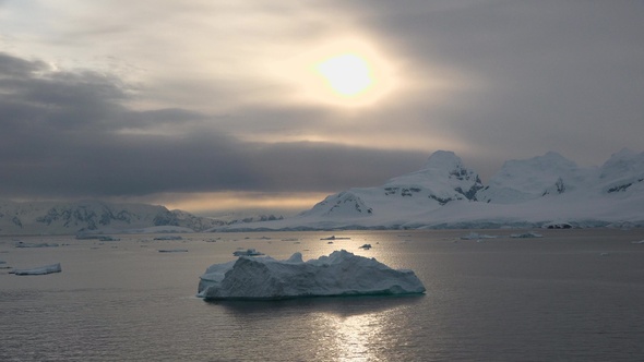 Greenland. Summer Midnight Sun and icebergs. Phenomenon of global warming and climate change.