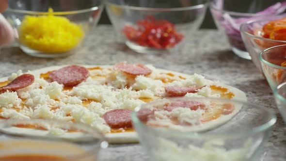 Topping Pizza with Salami Slices