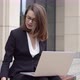 Woman in Formal Attire Using Laptop Outside Office Building - VideoHive Item for Sale