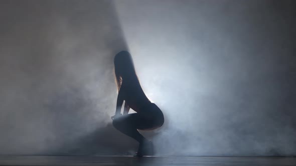 Performed Sports Girl in Dark Studio Booty Dance in Silhouette