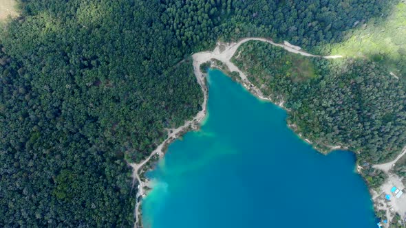 Aerial View of a Blue Lake Surrounded By Forest.