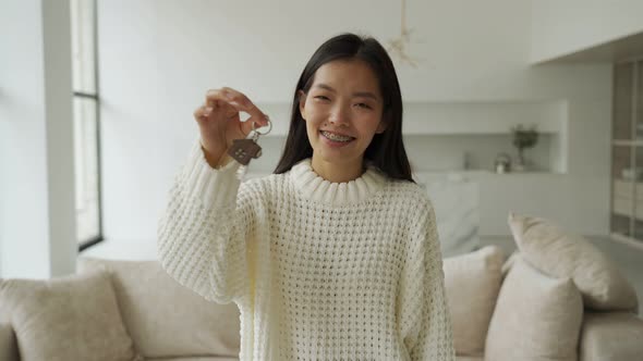 Young Asian Woman Gets the Keys to the House and Signs a Contract with a Real Estate Agency