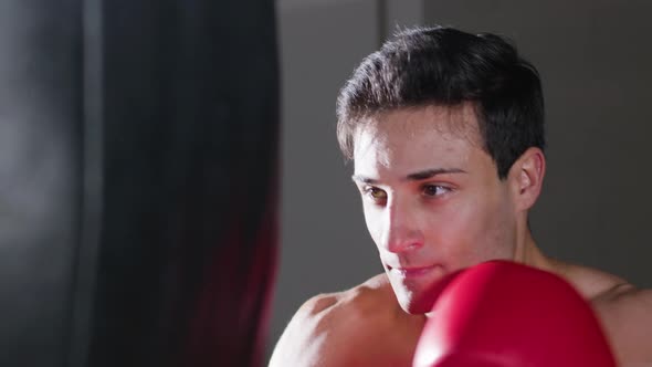 Closeup Shot of Attractive Young Man Boxing in Gym