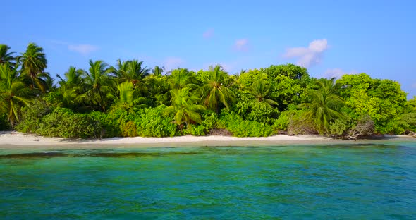 Daytime overhead travel shot of a white sandy paradise beach and blue ocean background in colourful 