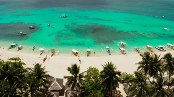 Tropical Daco Island with a Sandy Beach and Tourists.