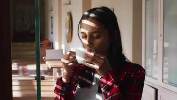 Mixed race woman drinking a cup of coffee
