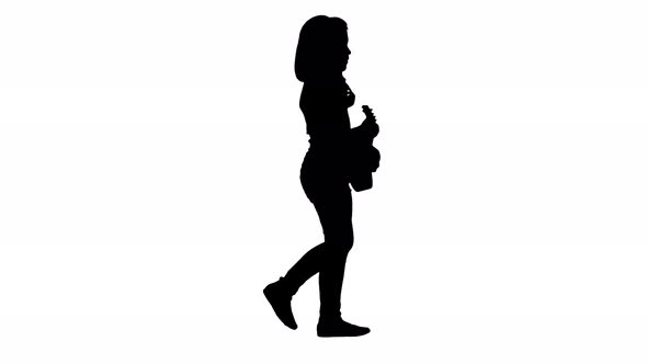 Silhouette A Little Girl Walking with Ukulele in Hands