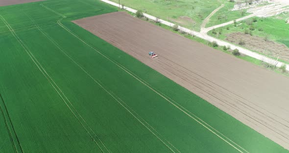 Aerial view of tractor sowing in agriculture area