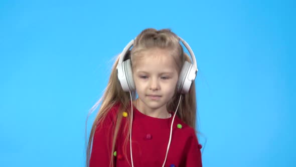 Little Girl Dancing and Listening To the Musik Through Headphones.