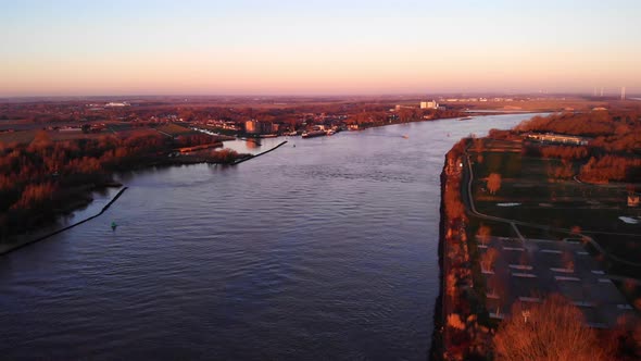 Aerial Landscape View Over Puttershoek With Autumnal Sunrise Fall Colours With Oude Maas Running Thr