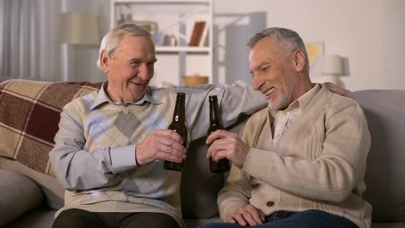 Old Friends Clinking Beer Bottles, Leisure Time at Home, Remembering Past