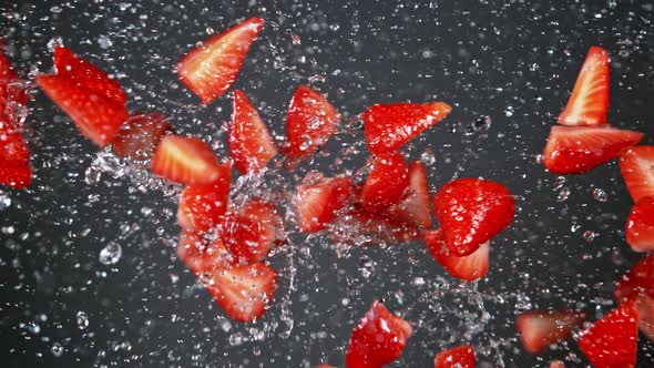 Super Slow Motion Shot of Fresh Strawberries and Water Side Collision on Grey Background at 1000Fps