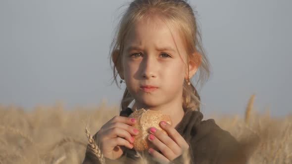 Hungry Child Eating Bread in Wheat Field, Summer Outdoor Lifestyle.