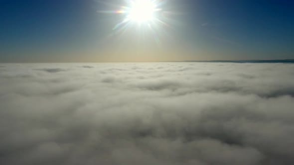 Aerial View, Flying Through Clouds at Sunset