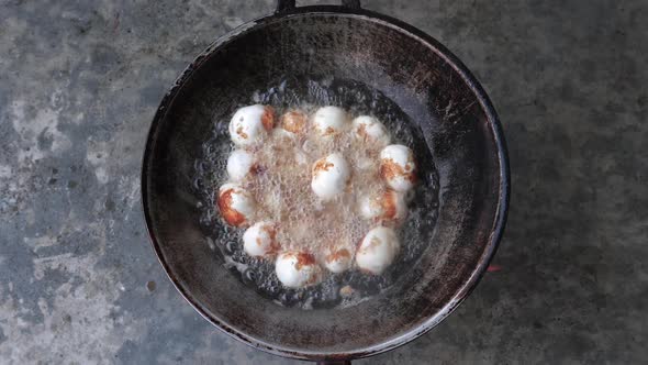 Top down shot deep fried duck eggs on old frying pan hot boiling - Thai cuisine