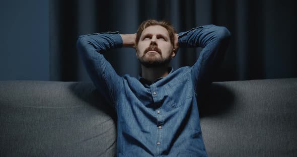 Depressed Man Sitting on Sofa