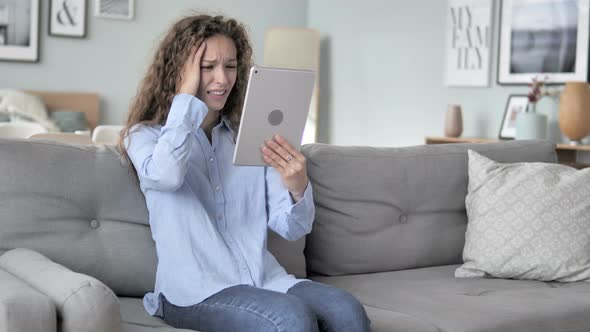 Curly Hair Woman in Shock by Loss while Using Tablet