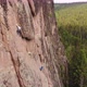Two Men Are Climbing a Vertical Granite Wall in the Middle of a Forest. - VideoHive Item for Sale