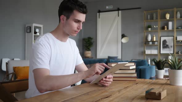 Man Using Tablet Sitting at Workplace