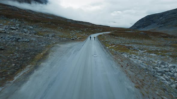 Following Flying Shot of Cyclist Training on Road