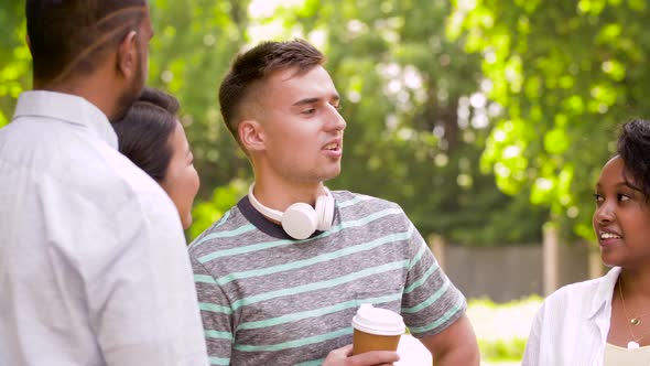 Happy Friends Drinking Coffee and Talking in Park 74