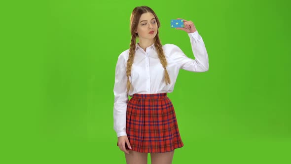 Girl Raises the Card and Shows a Thumbs Up. Green Screen