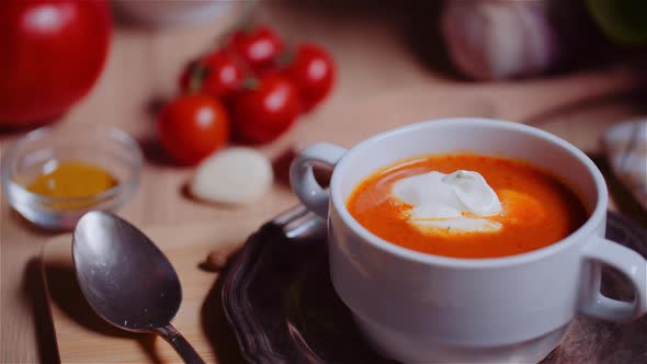 Tomato Soup Decorated with Creme on Table Rotating