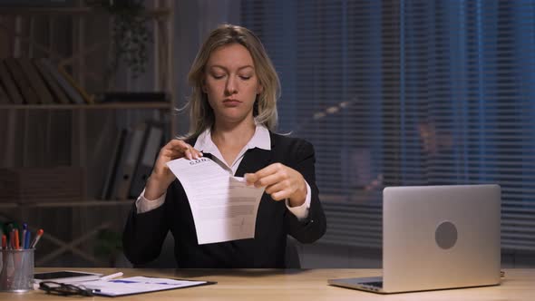 Businesswoman Holds Contract in Hands and Ripping It Apart