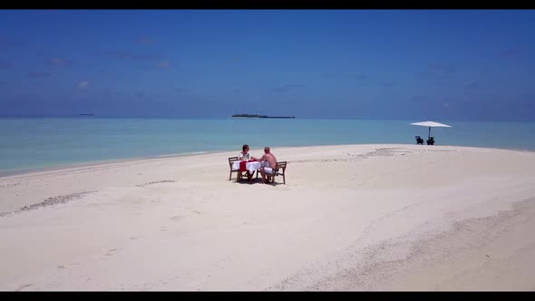 Man and lady suntan on tropical bay beach adventure by blue water with white sandy background of the