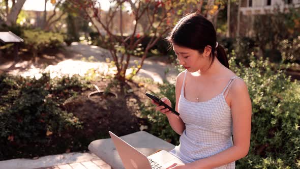 Asian college student  checks her social media