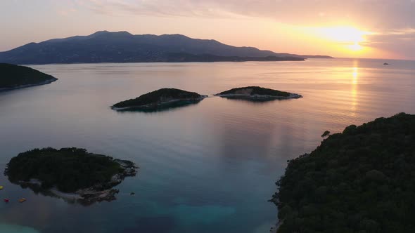 amazing sunset over seascape in Albanian Riviera, at Ksamil coastline. Aerial wide static shot