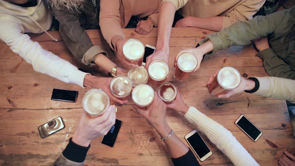 Group of friends enjoying a beer at pub in London