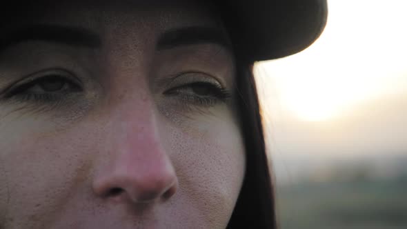 Portrait of Young Woman Looking Up at Sunset Sky