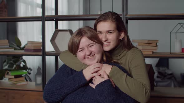 Portrait of Smiling Deaf Women Embracing at Home