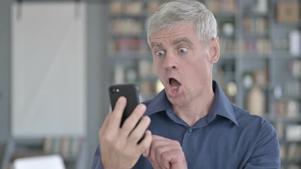 Portrait of Shocked Middle Aged Man Getting Upset on Smartphone